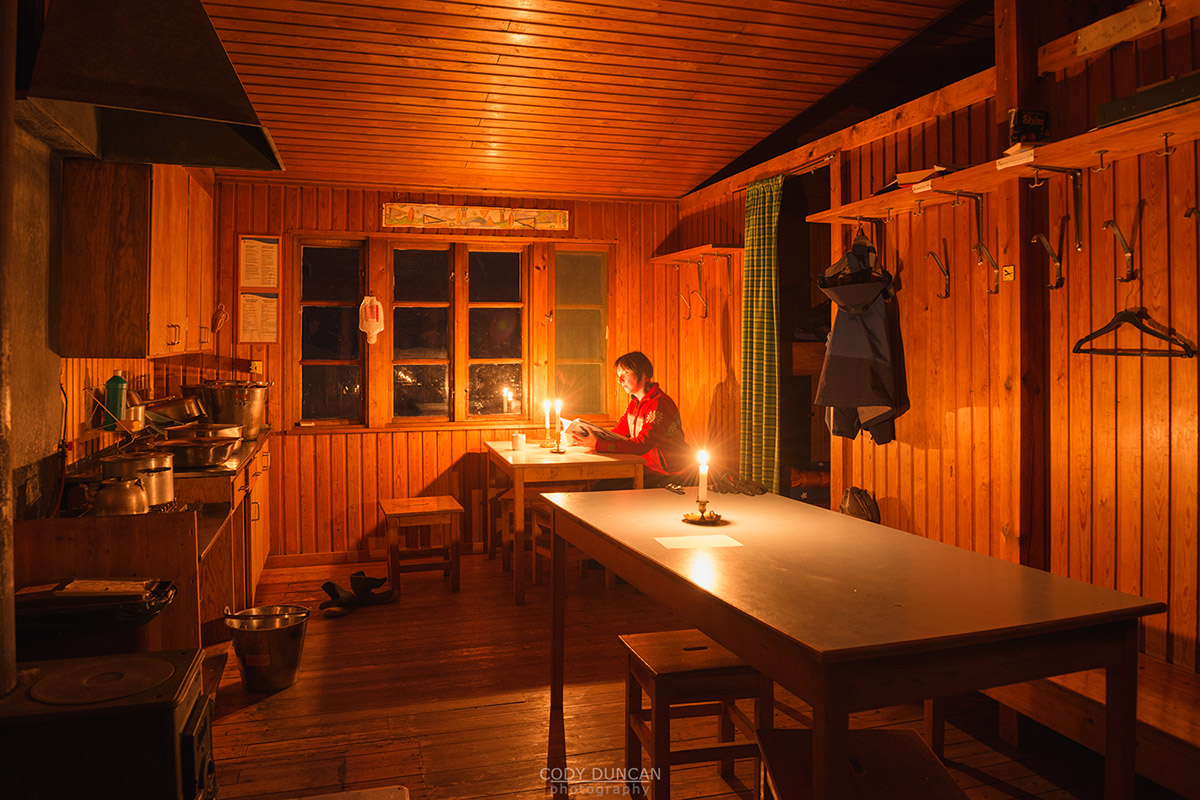 Candlelight illumintes room Singi mountain hut at night, Kungsleden trail, Lappland, Sweden